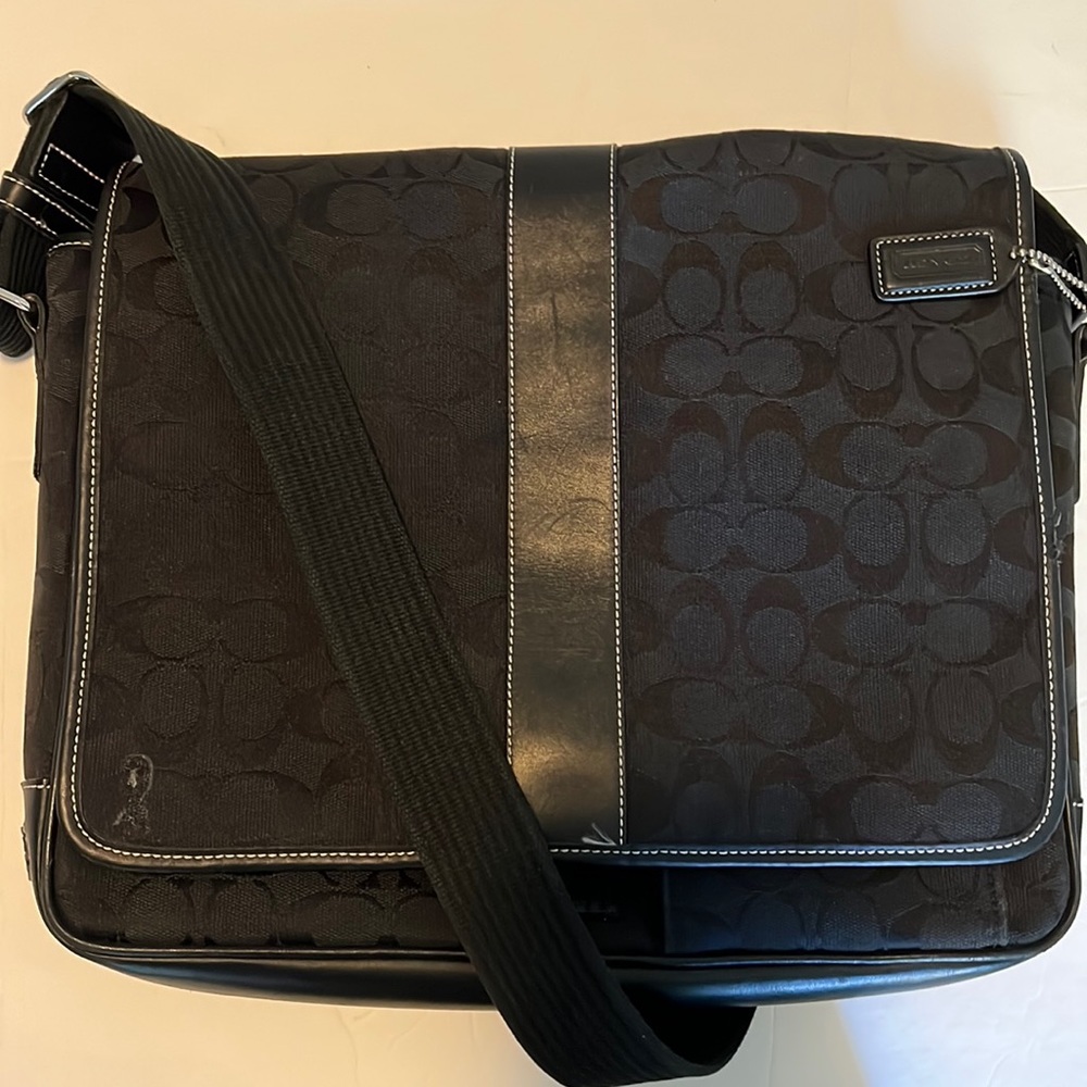 Black signature Coach messenger bag.